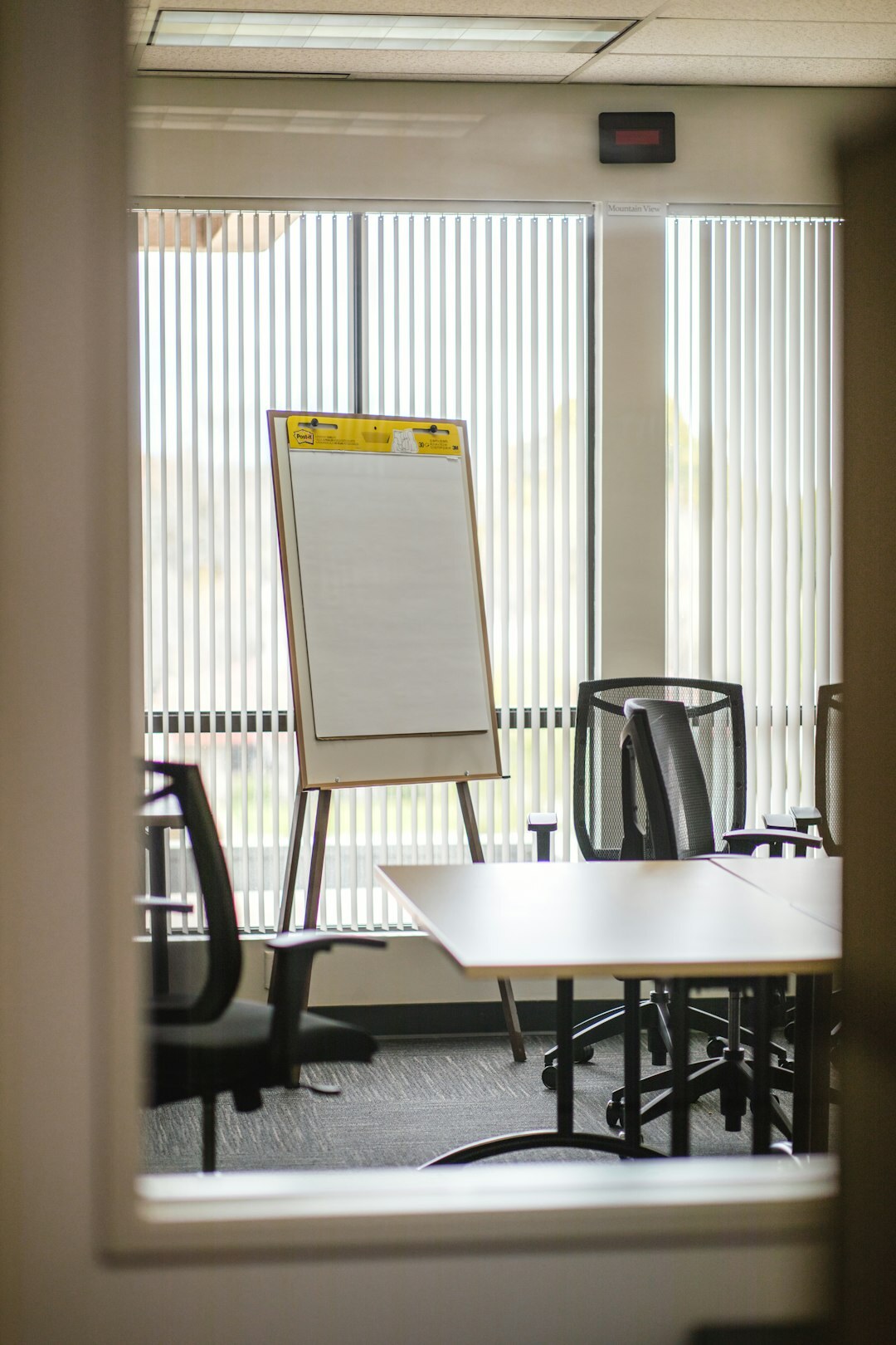 Facilitator leading a roundtable discussion with notes on a flip chart